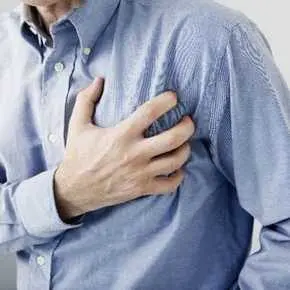 Person clutching chest in discomfort.