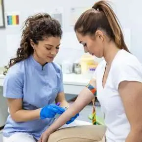 Nurse preparing to draw blood from patient.